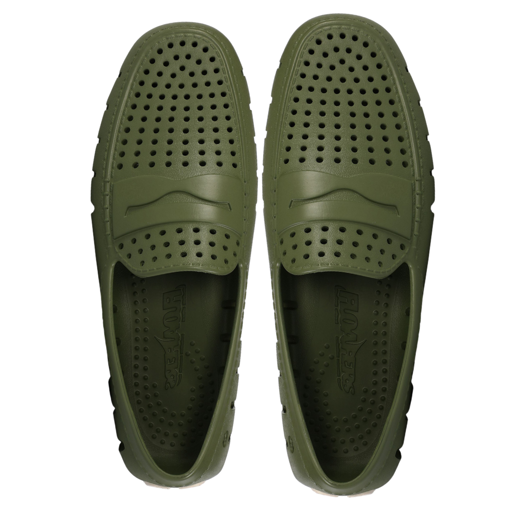 Pair of green slip-on shoes with perforated design on a white background