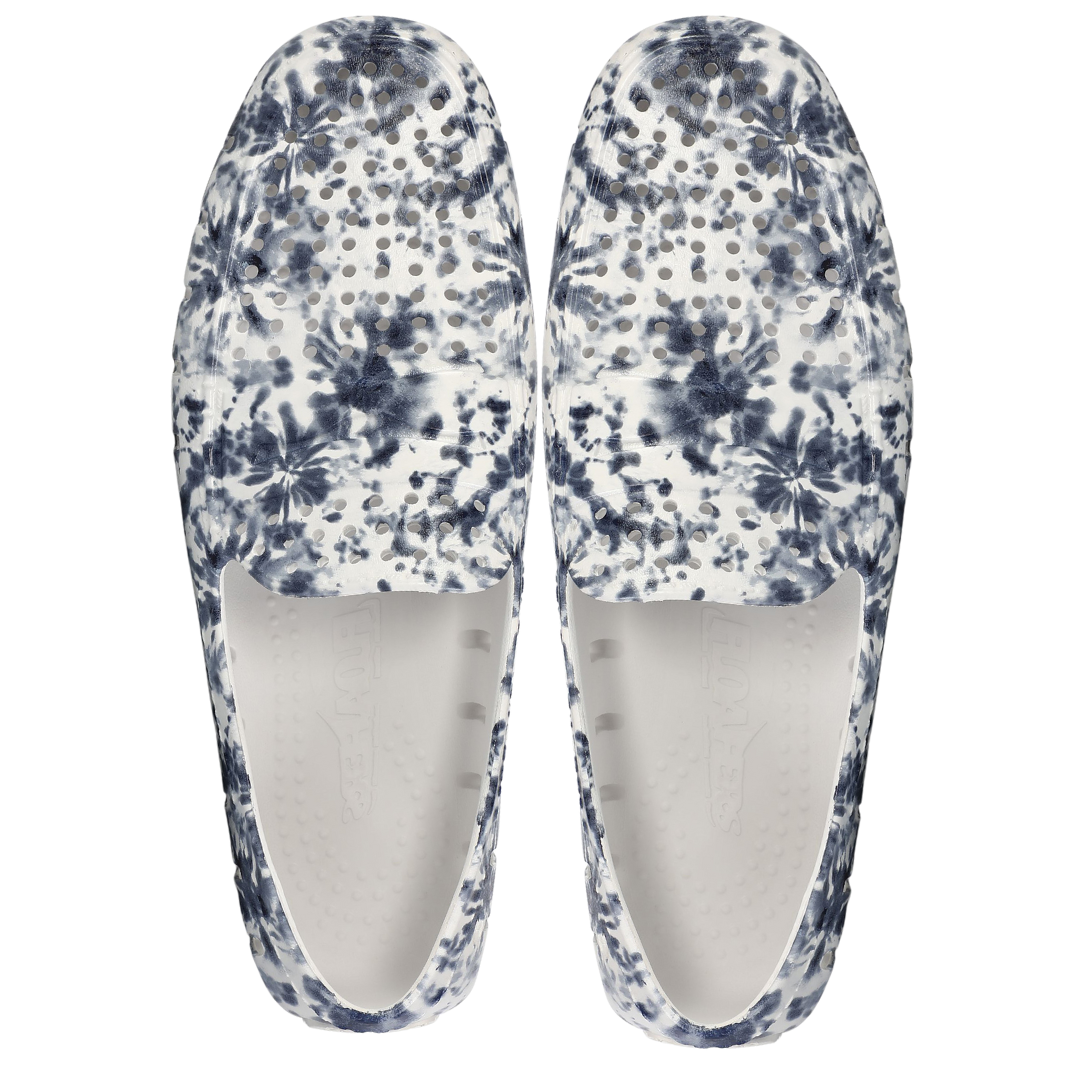 Pair of blue and white floral-patterned slippers on a white background
