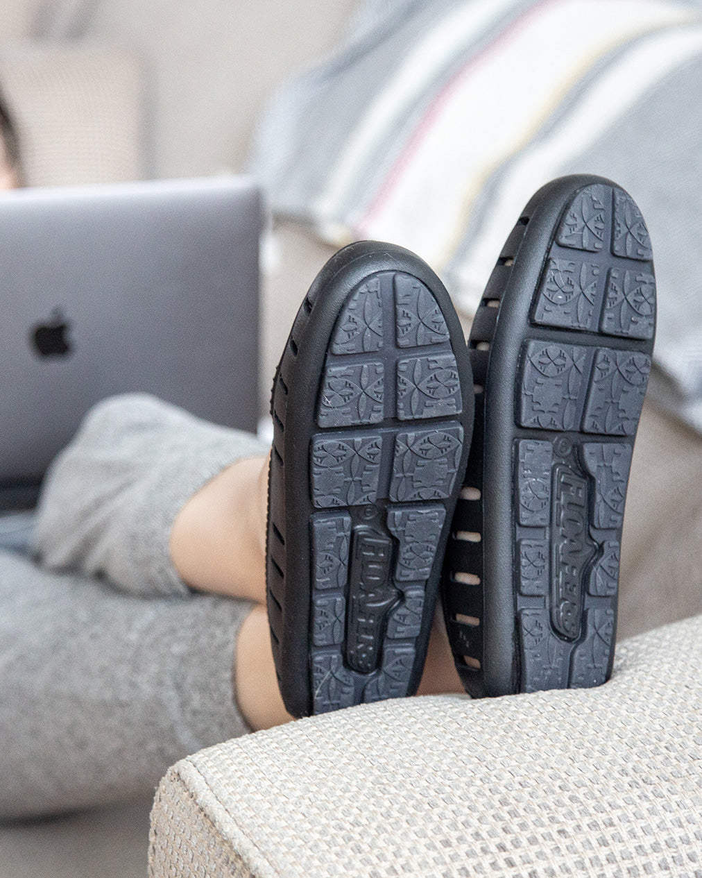 Woman wears Floafers shoes on couch