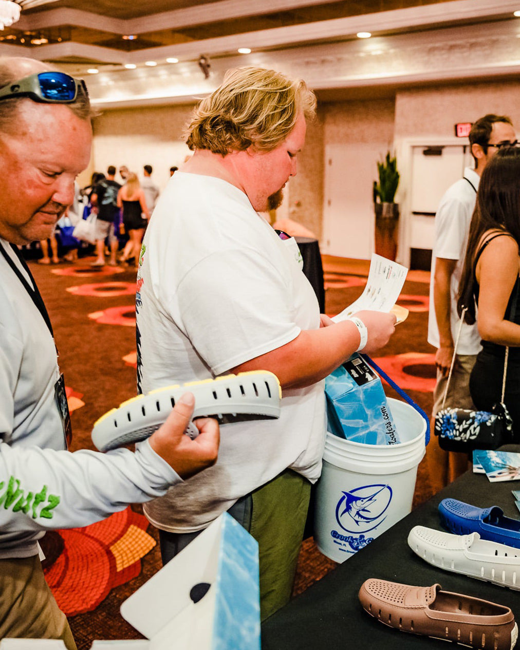 Men inspecting Floafers shoes at convention