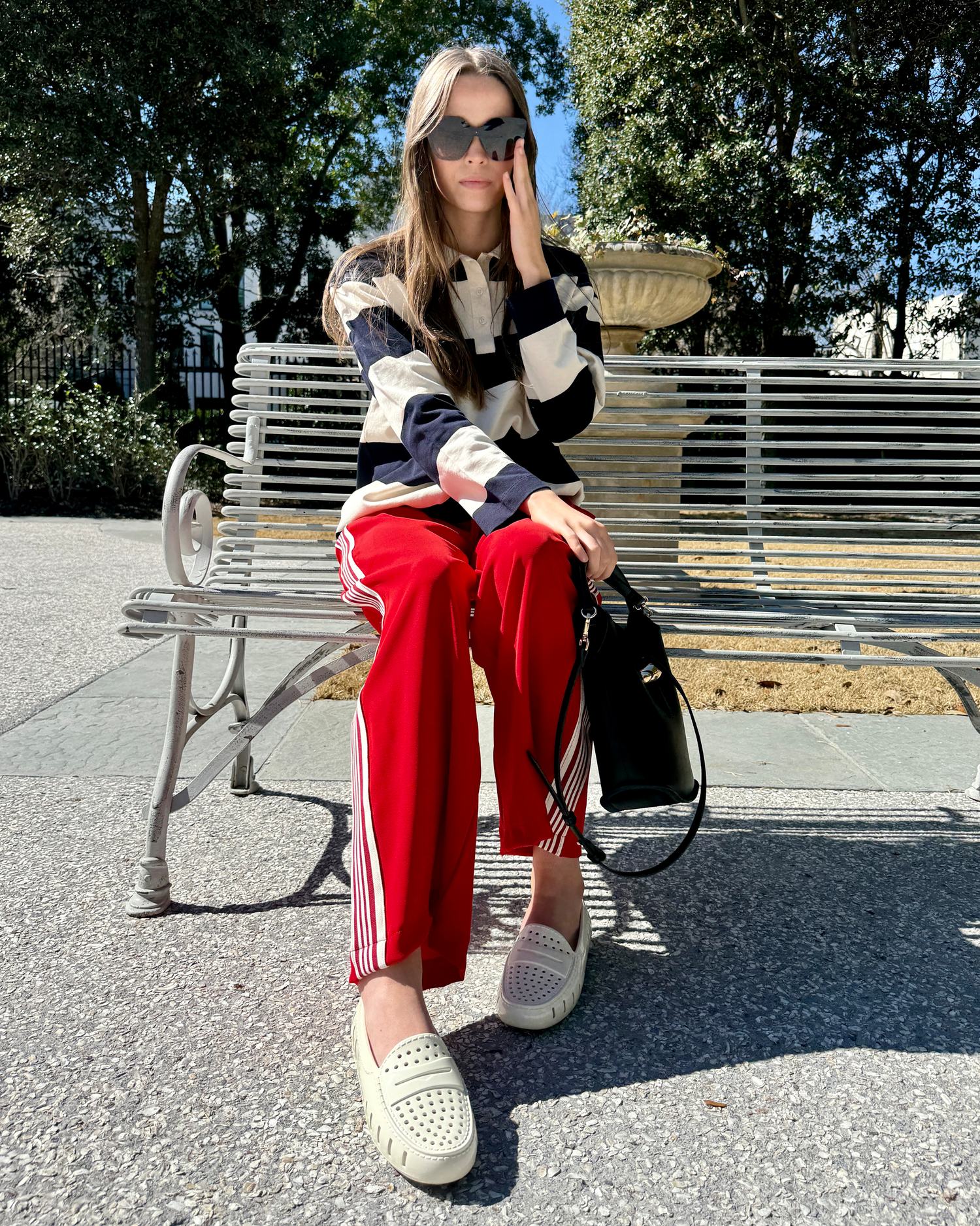 Women on park bench wearing white floafers