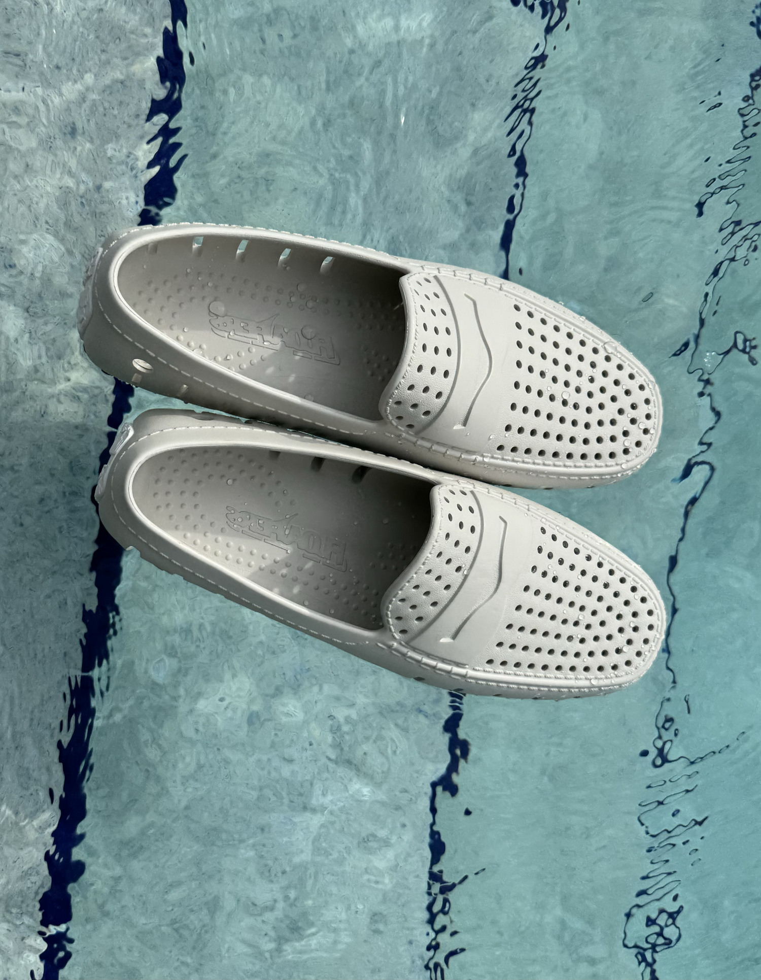 White slip-on shoes on a blue textured background