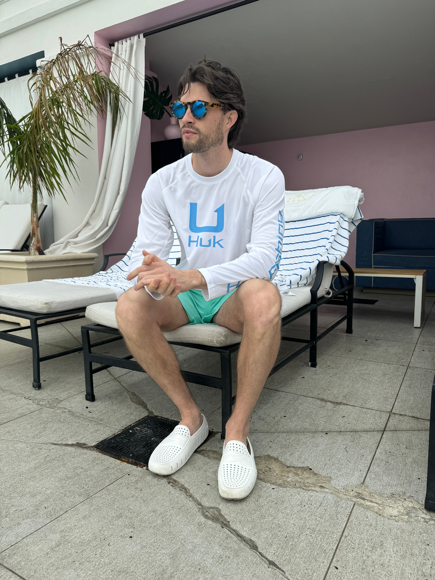 Man in pool chair wearing white floafers