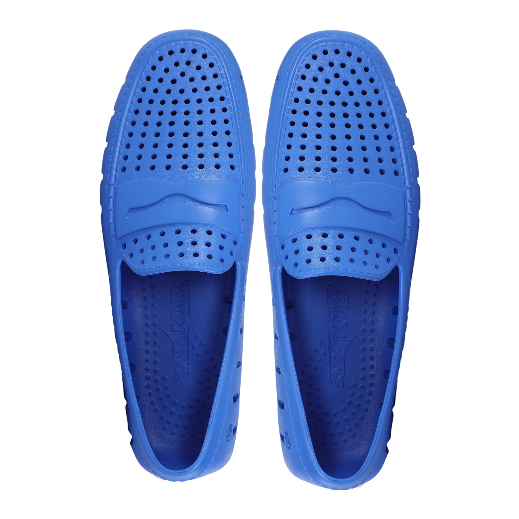 Pair of blue slip-on shoes with perforated design on a white background