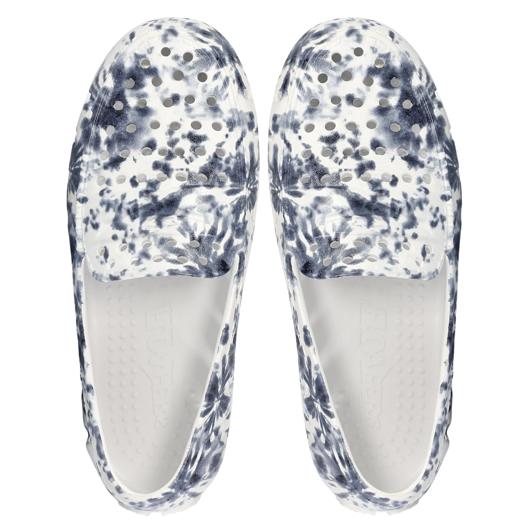 Pair of blue and white marbled slip-on shoes on a white background